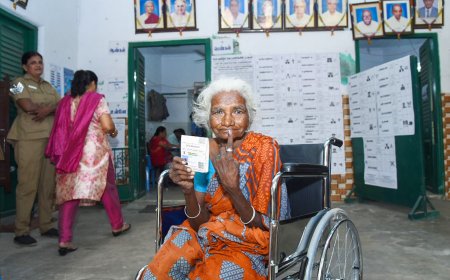 An elderly woman voter showing mark of indelible ink after casting her vote, at a polling booth in Chennai